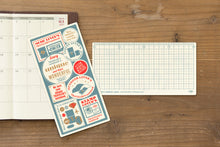 Laden Sie das Bild in den Galerie-Viewer, TRAVELER'S COMPANY - Traveler's Notebook Regular - 2027 Plastik Schreibunterlage